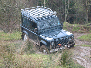Land Rover Defender driving though mud