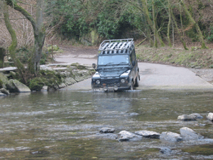 Land Rover Defender driving through water